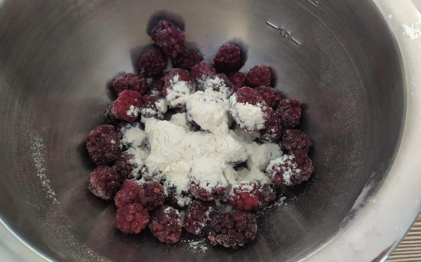 Coat the berries with flour so they don't sink in the batter.