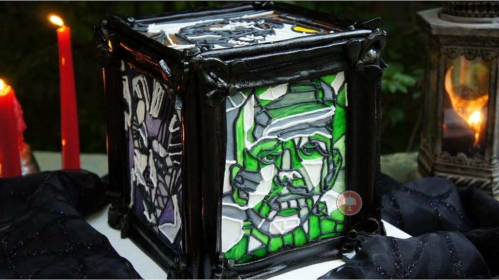 Frankenstein Cake - An Amazing Halloween Cake for Spooktacular 3 frankenstein cake in picture box frame on a table with candles for halloween monster mash