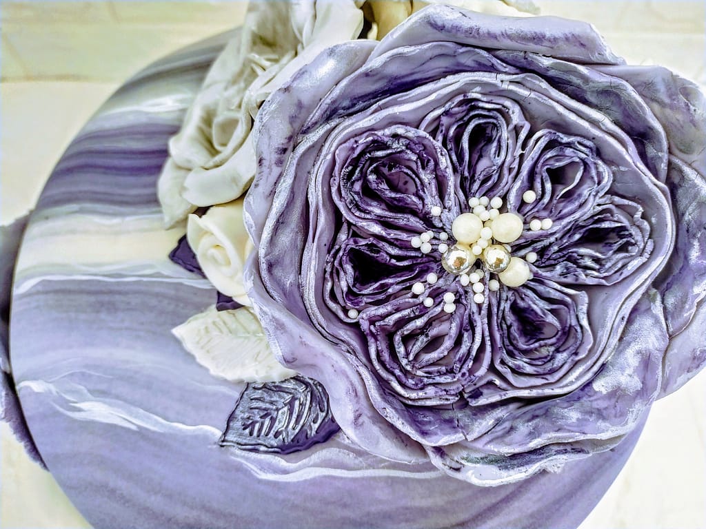 How to Create an Elegant Birthday Cake for Women 3 top view of elegant birthday cake showing fondant flower cake topper