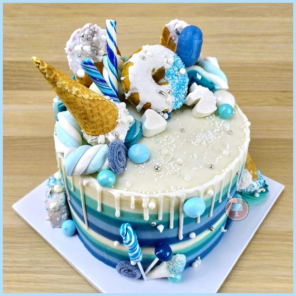 candy striped cake with drips and blue color palette