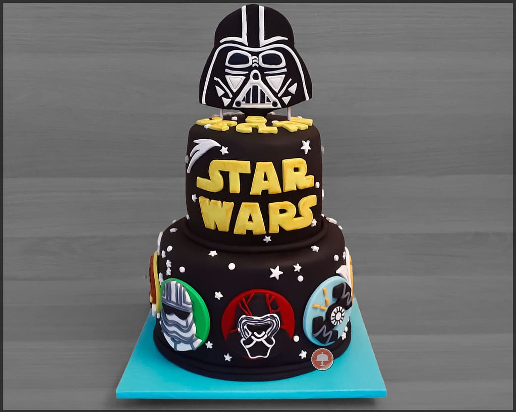 star wars cake with black fondant and darth vader cake topper