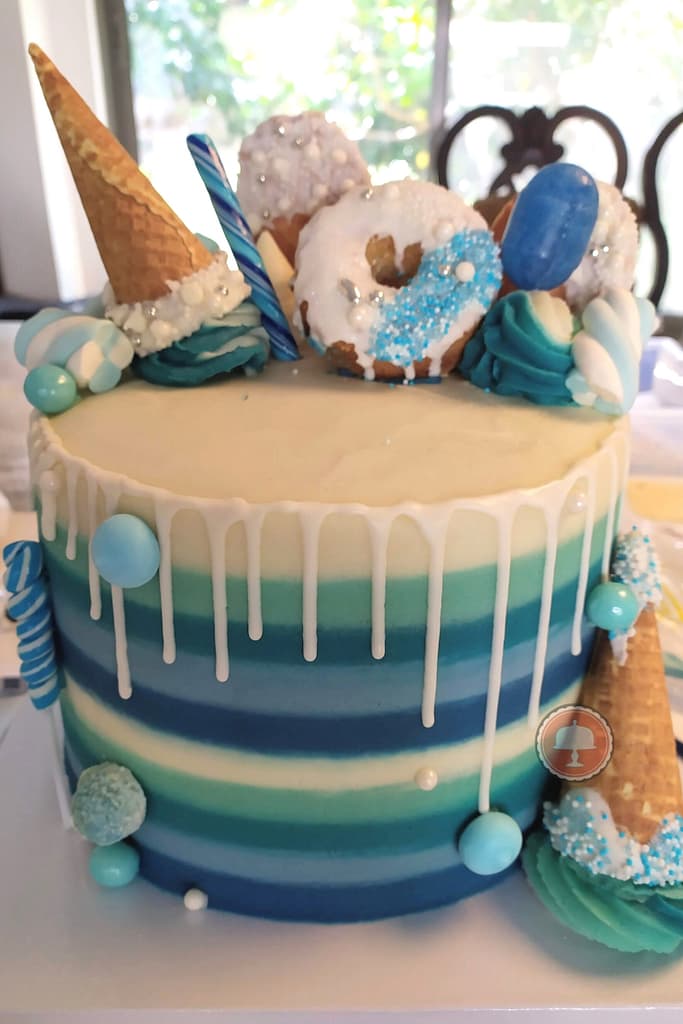 candy-striped drip cake buttercream stripes white chocolate drip celebration cake birthday cake blue teal white color palette 