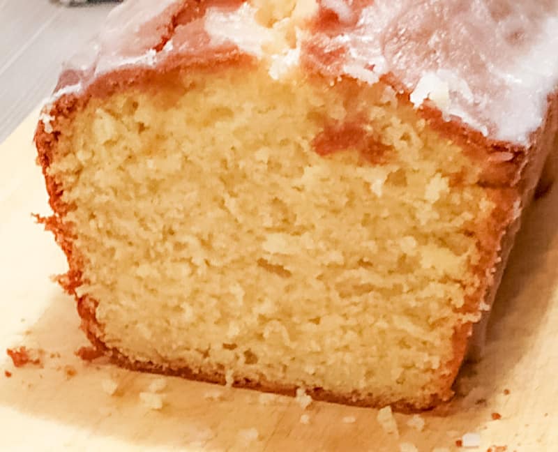 Fluffy Lemon Loaf Cake Recipe - with fresh lemon glaze 3 lemon loaf cake showing the inside of the cake with fluffy lemon and a sugar drizzle on top